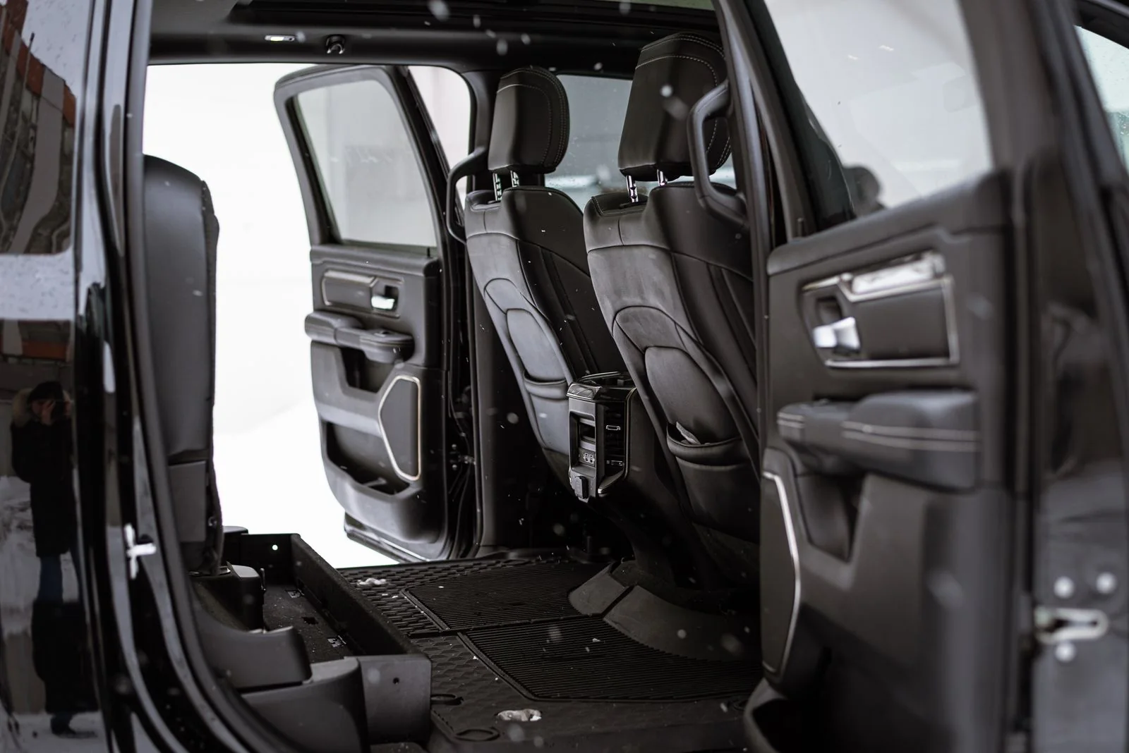 Open car interior with black seats and floor mats, illustrating car cleaning with INTETURE Cordless Vacuum